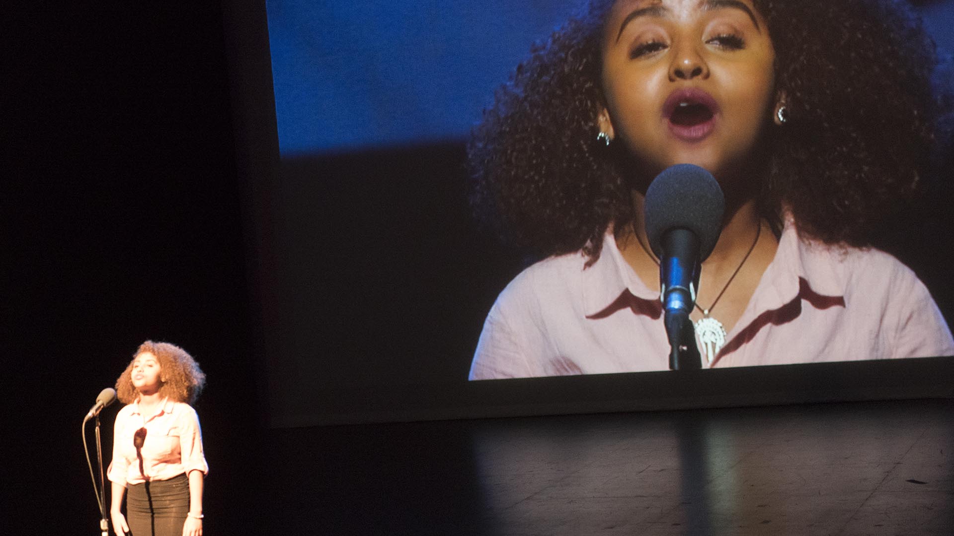 Tsion Berie from Calgary’s Notre Dame High School recites “At the Centre” by Afua Cooper.