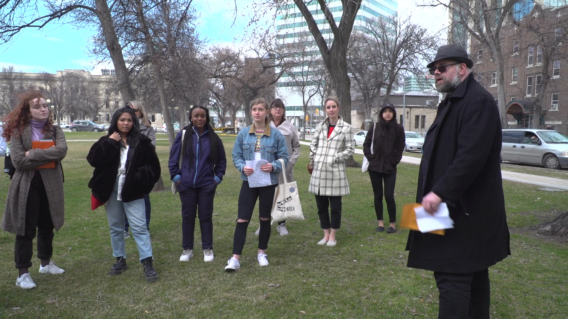 Kristian Enright discusses poetry and Winnipeg's Scottish heritage in front of the statue of poet Robert Burns at the Manitoba Legislative Building.
