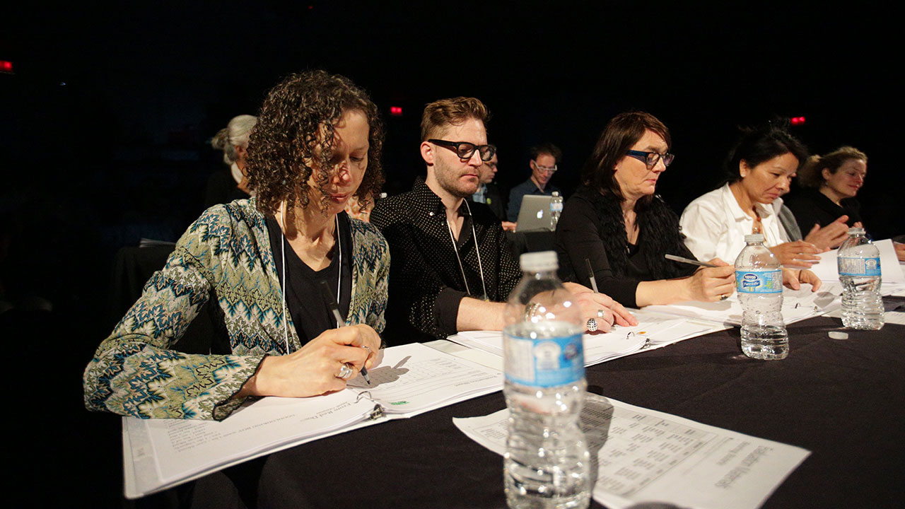 The judges review their score sheets. (l to r: Stephanie Bolster, Jeramy Dodds, Sina Queyras, Rita Mestokosho, and Jeanne Painchaud)
