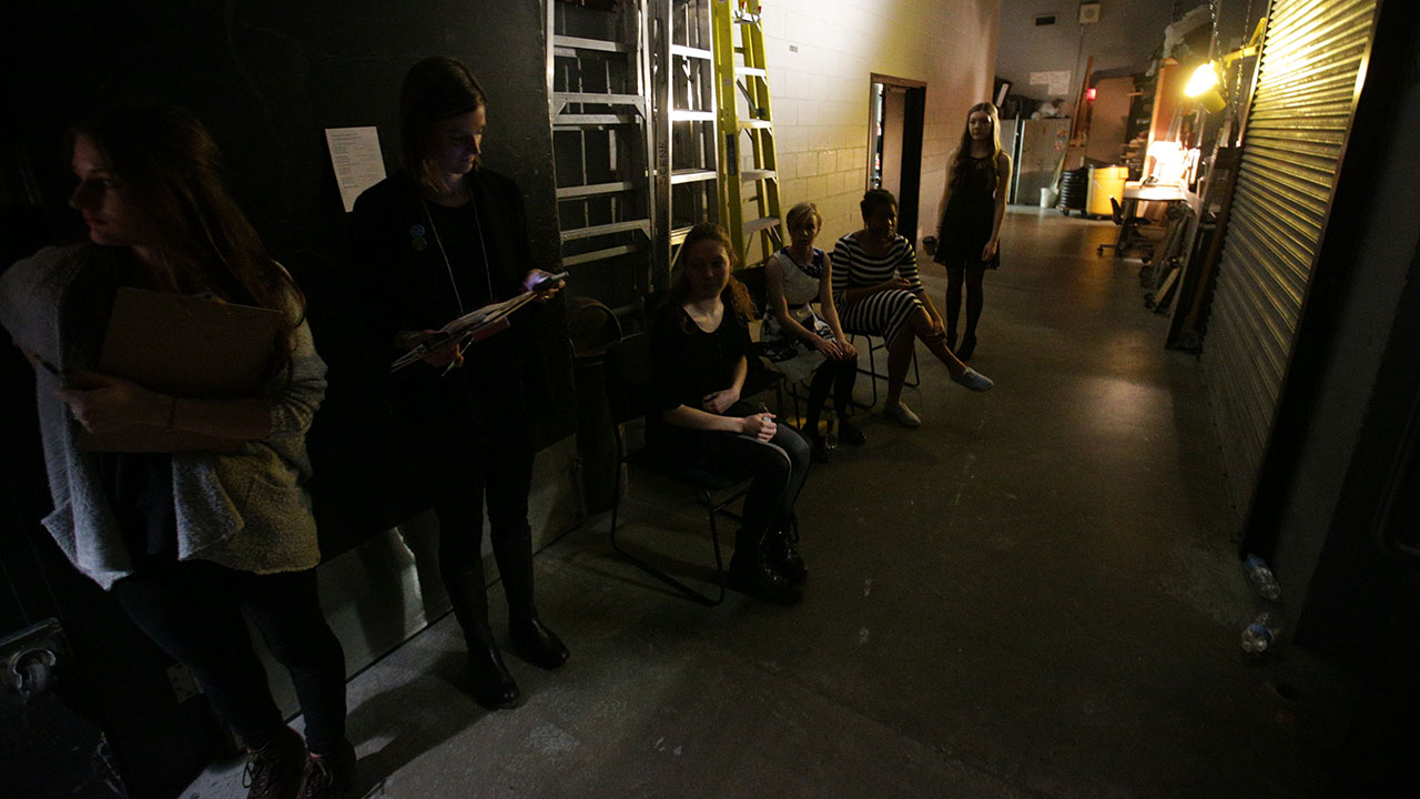 The finalists wait backstage for the house to close.