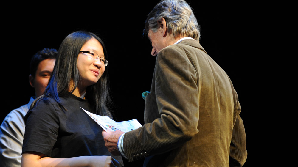 Founder Scott Griffin awards second-place winner Anna Jiang her certificate of participation and her $1,000 in prize money.