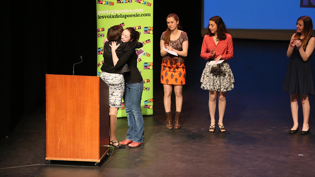 Kelsi James from Dr. Charles Best Secondary School is the 2014 National Bilingual Champion. Here, she is being congratulated by Johanne Blais as Marianne Verville, Andrea Rodriguez-Marin, and Madina Sutton look on.